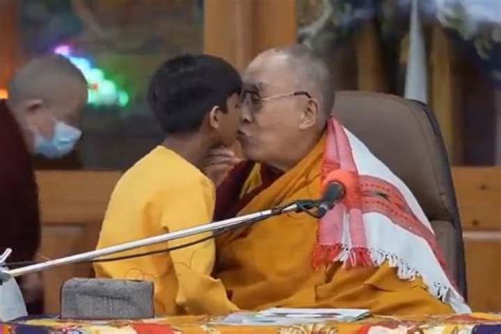 
Dalai Lama apologizes after kissing young boy on the lips, telling him to suck his tongue 